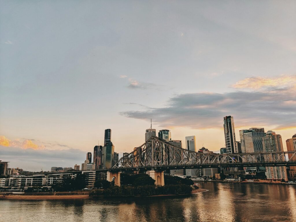 Scenic view of Brisbane skyline with Story Bridge at twilight over the Brisbane River.
